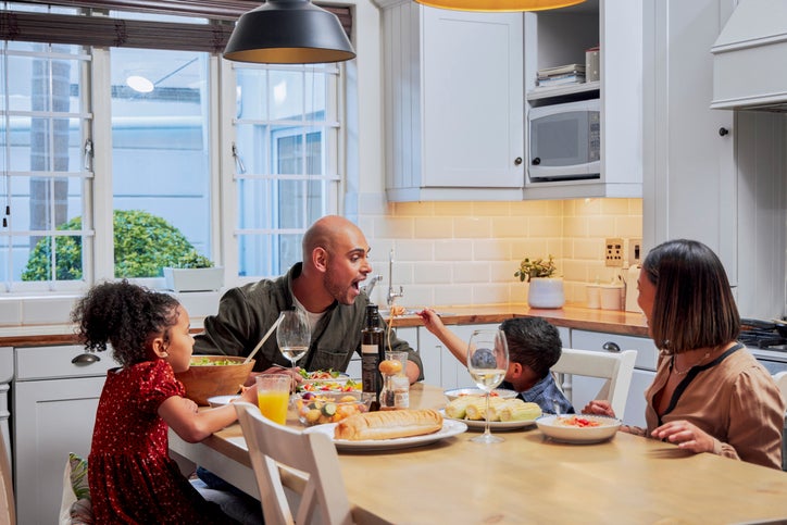 Shot of a young family enjoying a meal together