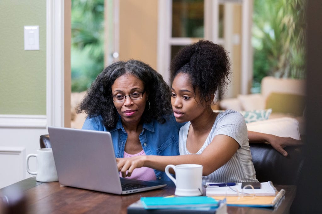 woman helping child refinance student loans