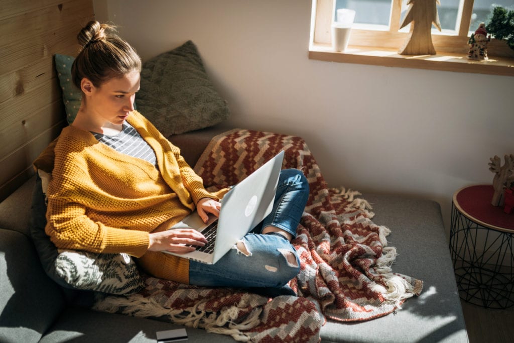 young woman researching student loan refinancing requirements