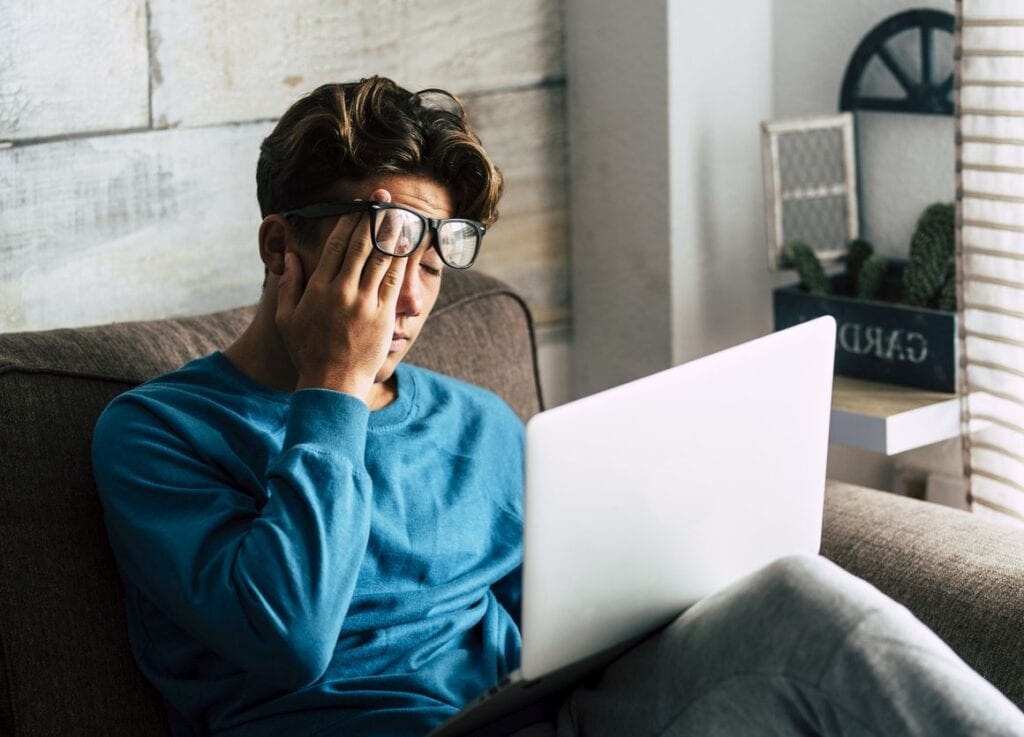 Man feeling overwhelmed by student loans