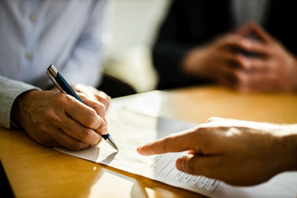 Cosigner signing student loan paperwork