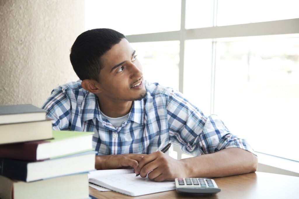 Young man considering whether student loans are worth it