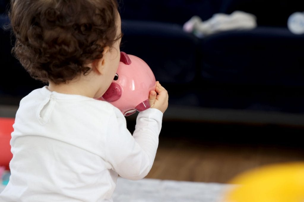 baby girl with piggy bank