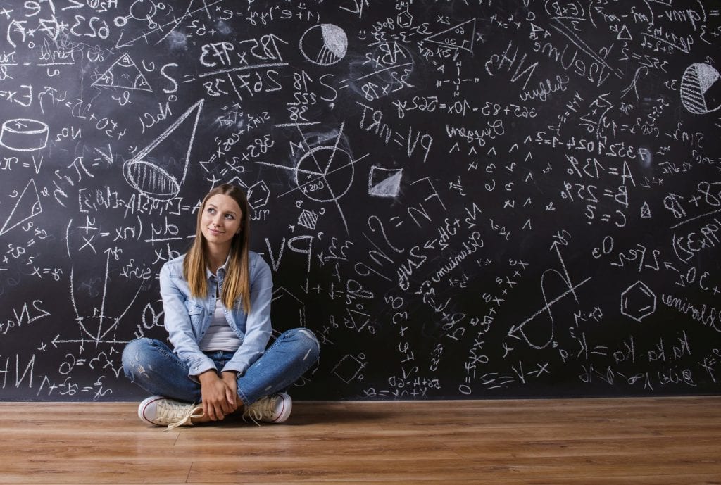 young female student in front of blackboard