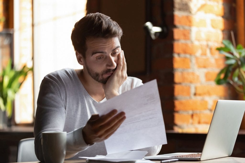 Young man looking at debt