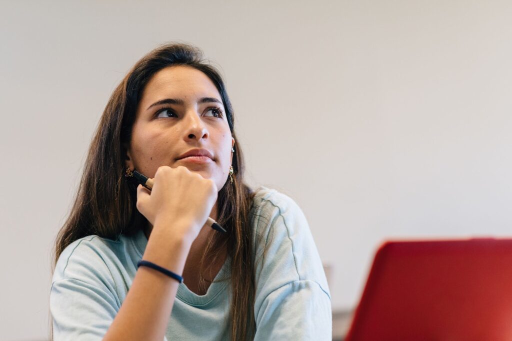 Woman wondering what happens to student loans if you drop out