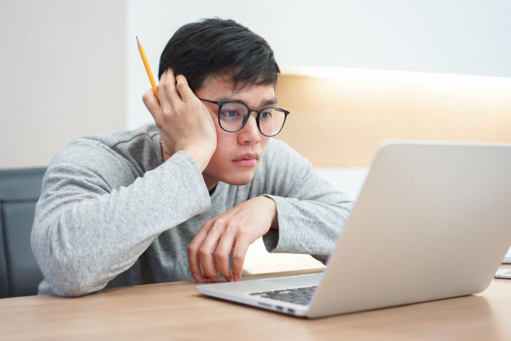 asian student using laptop