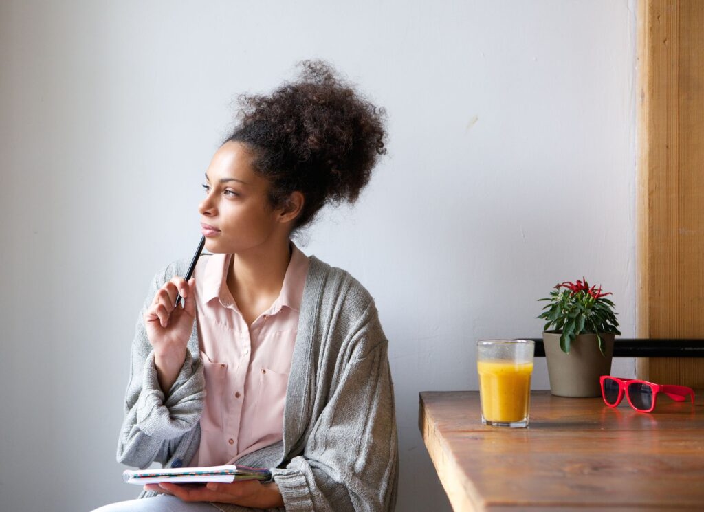 Young woman with pen and paper