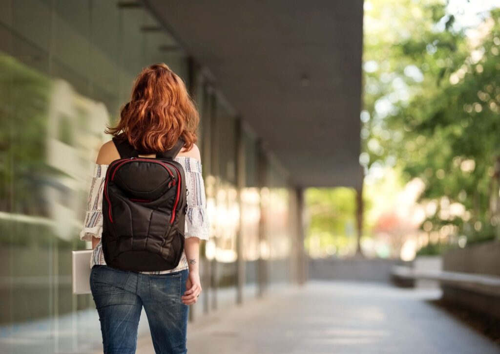 young female university student with backpack