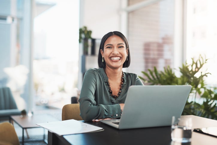 Shot of a young businesswoman using a laptop in a modern office