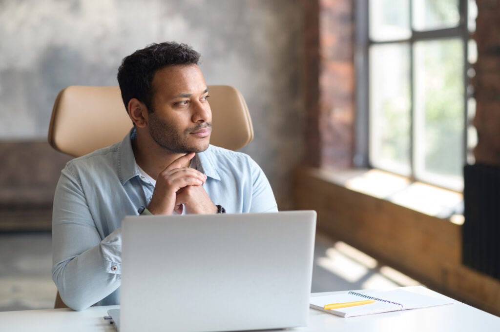 Man contemplating if he should use his 401k to pay off student loans