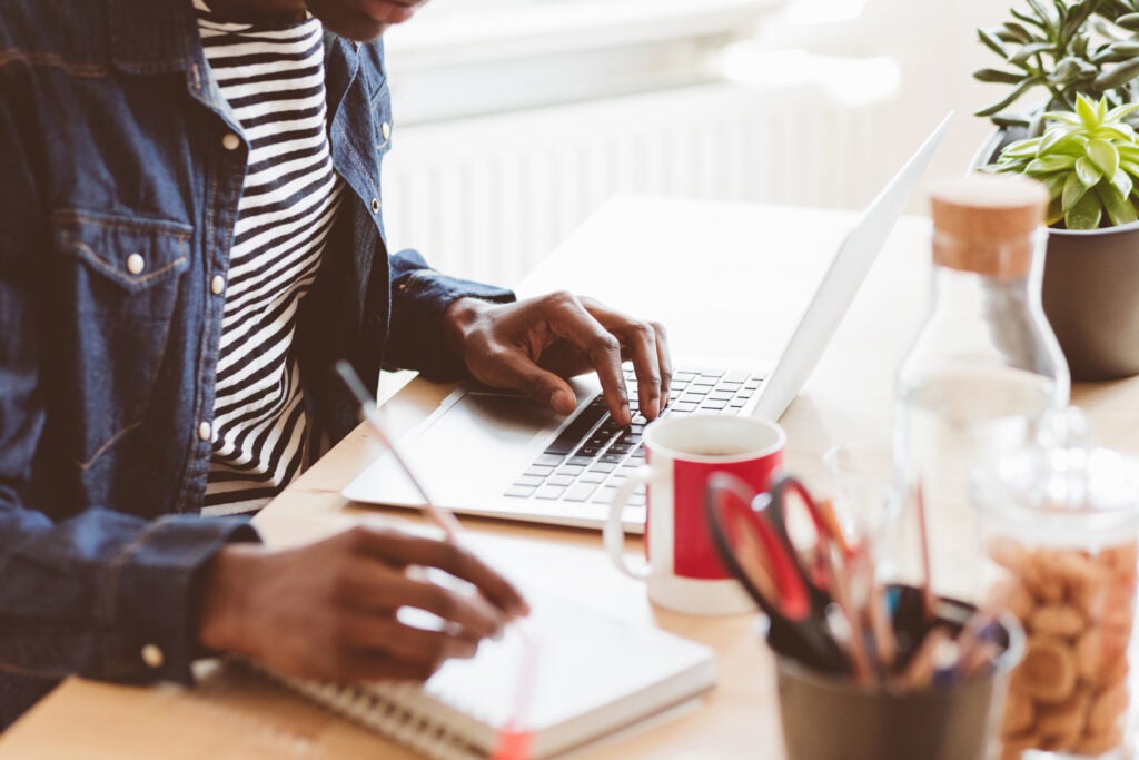 Man with student loans researching if he is eligible for loan forgiveness after 20 years