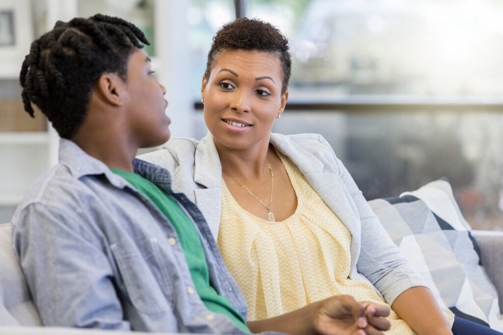 Teen talking to parents about paying for college