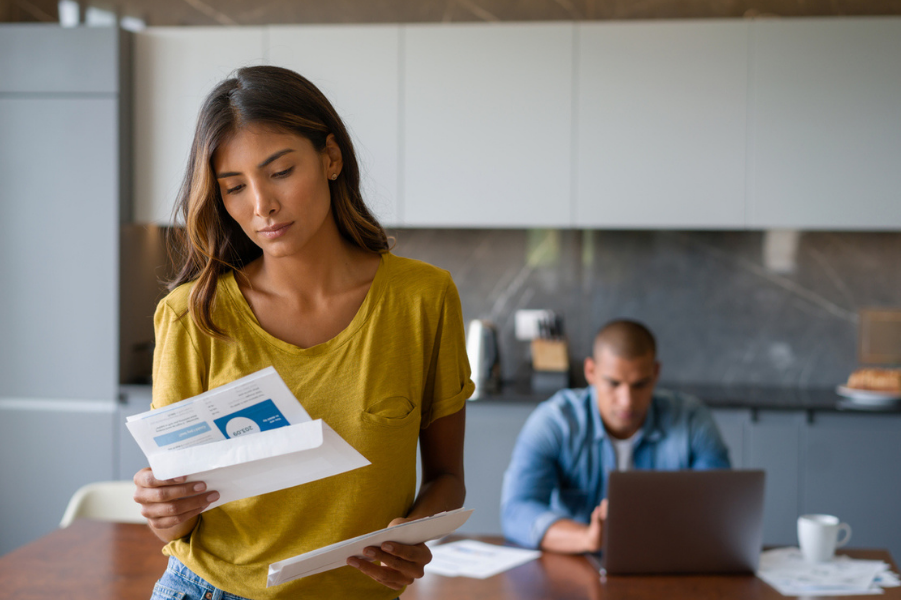 A woman looking over ways to lower her debt to income ratio.