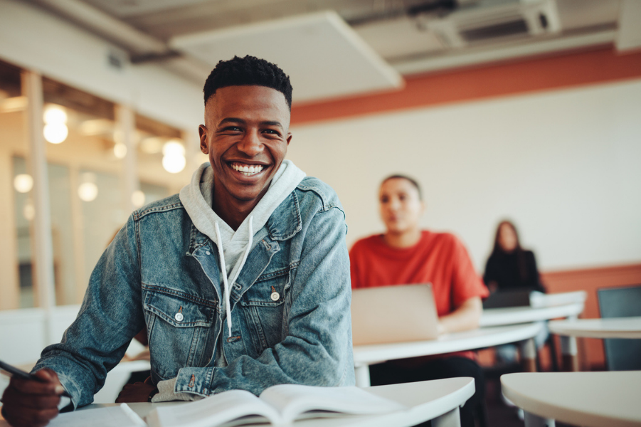 Male high school student learning ways to save money for college.