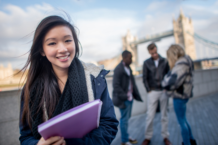 Young Asian woman using student loans to study abroad.