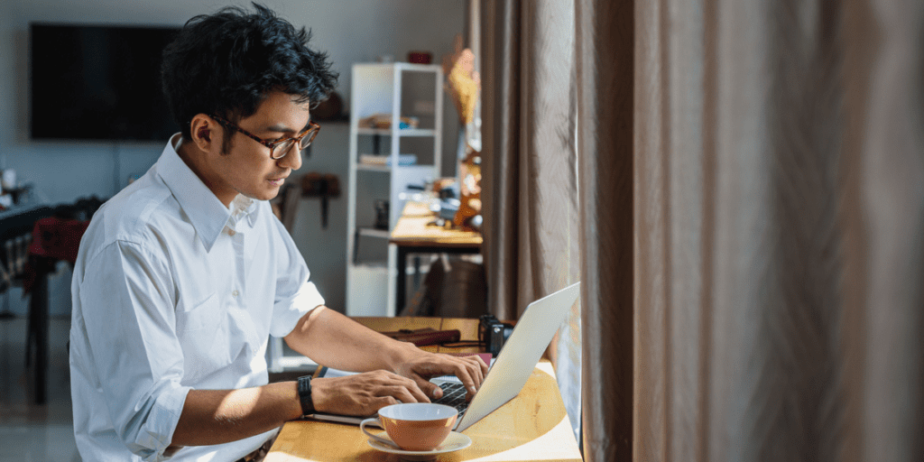 Young Asian man working on his computer.