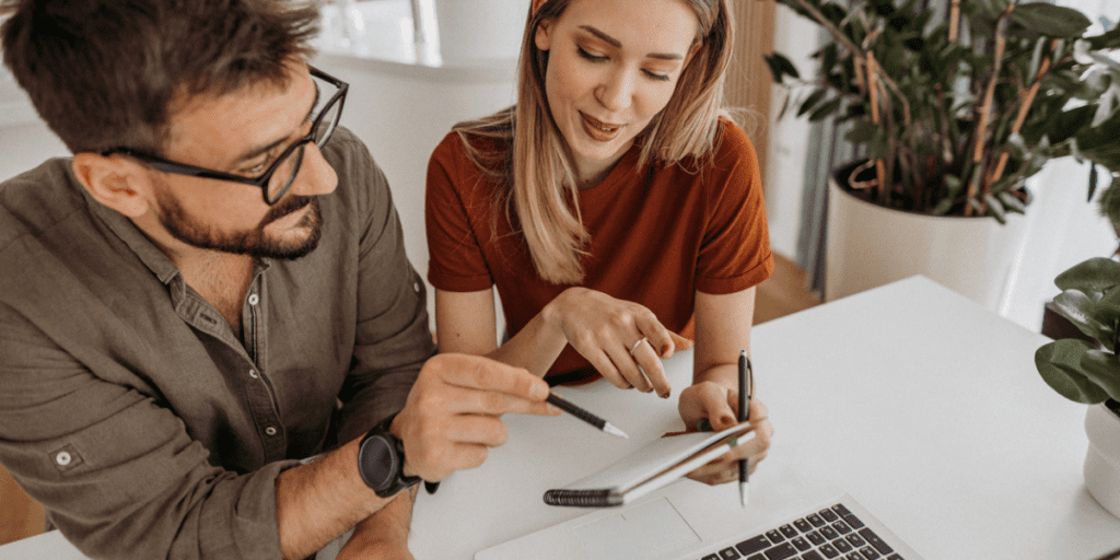 Husband and wife going over the pros and cons of paying off student loans early.