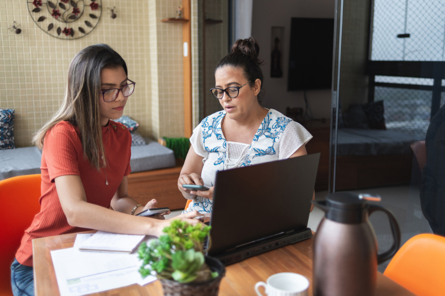 Daughter and mother going over college finances.