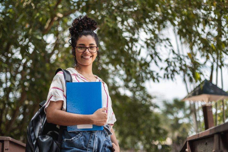 Young female college student standing on campus.