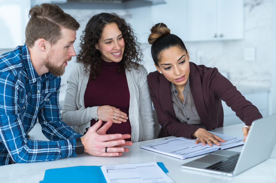 Expecting parents meeting with financial advisor for college funds.