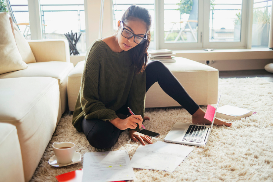 Young female college student going over finances.