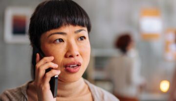 Close up portrait of an Asian woman on the phone