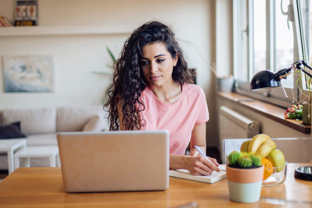 Young woman looking up ways to lower student loan payments.