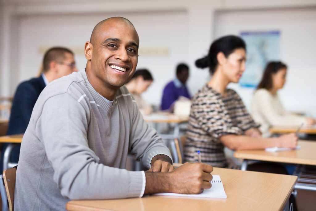 Older adult college student sitting in class after going back to school.