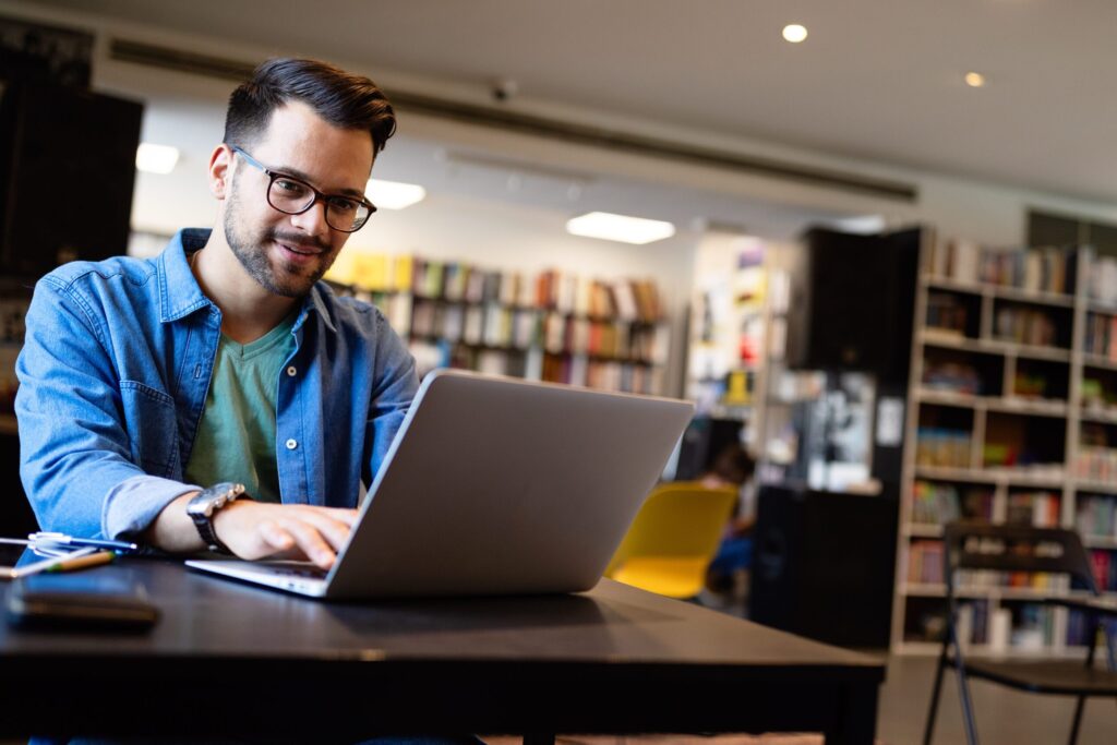 Male college student looking up if he can use personal loans for college.